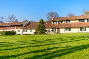 a large building with a large green field in front of it at Country Hotel Castelbarco in Vaprio dʼAdda