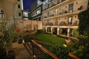 an apartment building with a lawn in the courtyard at Angelis in Prague