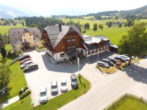 an overhead view of a large building with cars parked in a parking lot at Hotel Neuwirt in Ramsau am Dachstein