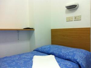 Postel nebo postele na pokoji v ubytování Hotel Graziana