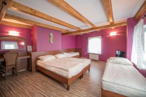 a bedroom with two beds and a table and a mirror at Dworek Galosa in Stronie Śląskie +119 photos