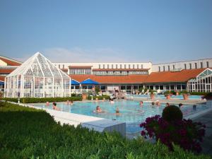 a group of people swimming in a swimming pool at Apparthotel Minerva Diana Octavia in Bad Gögging