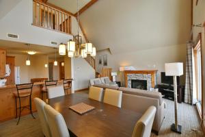 a dining room and living room with a table and chairs at The Blue Escape Blue Mountain Chalet in Blue Mountains