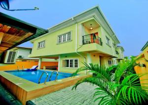 a house with a swimming pool in front of it at Casabella 2 BED VGC in Lekki