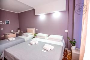 Postel nebo postele na pokoji v ubytování Hotel Paganini