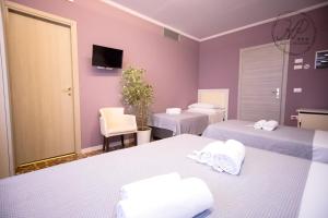 Postel nebo postele na pokoji v ubytování Hotel Paganini