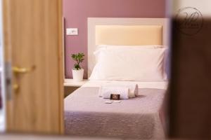 Postel nebo postele na pokoji v ubytování Hotel Paganini