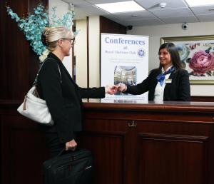 a woman is standing in front of a counter at Royal Maritime Club in Portsmouth