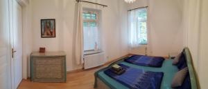 a bedroom with a bed and a dresser and a window at Ferienwohnung Schloß am Schloßberg in Bad Berka