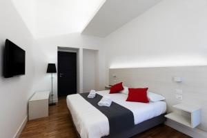 a bedroom with a large bed with red pillows at Acate81 Lifestyle Apartment in Naples