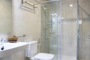 a bathroom with a shower and a toilet and a sink at Solesperit in Lloret de Mar