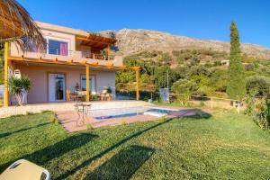 a house with a swimming pool in a yard at Villa Despina 2 Plakias Private Villa, Private Swimming Pool Garden, Panoramic Sunset in Asómatoi