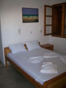 a bedroom with a bed with two towels on it at Dolphins House in Kinira
