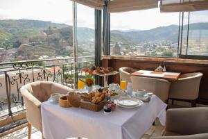 a table with food on it in a room with a view at KMM Hotel in Tbilisi City