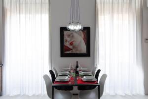 a dining room with a red table and chairs at Acate81 Lifestyle Apartment in Naples