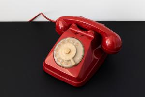 a red phone is sitting on a table at Acate81 Lifestyle Apartment in Naples