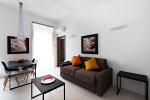 a living room with a couch and a table at Acate81 Lifestyle Apartment in Naples