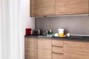 a kitchen with a sink and a counter top at Acate81 Lifestyle Apartment in Naples