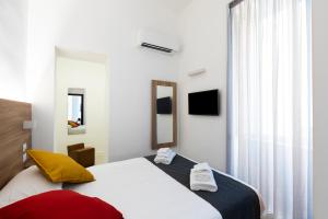 a hotel room with a bed and a window at Acate81 Lifestyle Apartment in Naples