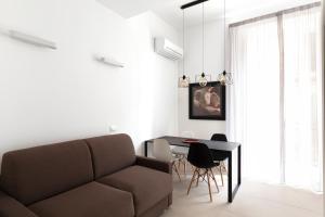 a living room with a couch and a table at Acate81 Lifestyle Apartment in Naples