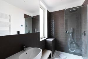 a bathroom with a sink and a shower at Acate81 Lifestyle Apartment in Naples