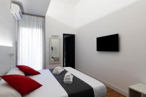a bedroom with two beds with red pillows at Acate81 Lifestyle Apartment in Naples