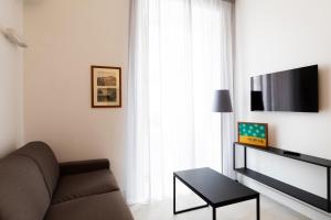 a living room with a couch and a flat screen tv at Acate81 Lifestyle Apartment in Naples