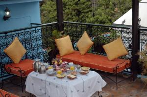 a table with food on it on a balcony at Riad Lahboul in Meknès