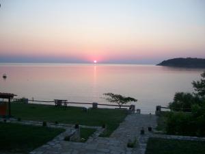a sunset over a body of water at Dolphins House in Kinira