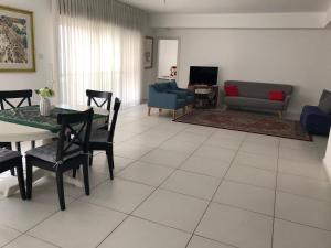 a living room with a table and chairs and a couch at Luxurious Huge 5R in Jerusalem center in Jerusalem