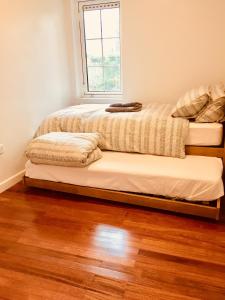 a bedroom with two beds and a window at Tapestry Apartment in London