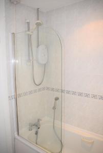 a bathroom with a shower and a bath tub at Kelpies Serviced Apartments-McKay in Falkirk