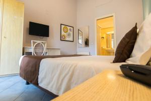 a hotel room with two beds and a flat screen tv at Hotel Soleluna in Piano di Sorrento