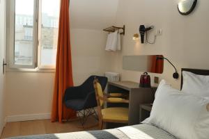 a bedroom with a bed and a desk and a window at Hotel Novex Paris in Paris