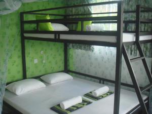 a bunk bed with two pillows and towels on it at Hiranya Mountain View Hostel Kandy in Kandy