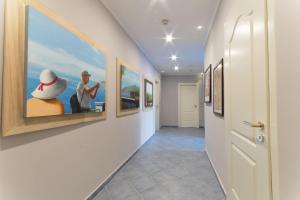 a hallway with paintings on the walls at Hotel Soleluna in Piano di Sorrento