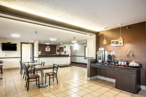 a kitchen and dining room with a table and chairs at American inn and suites in Galesburg