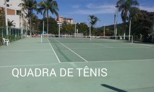 a tennis court with two tennis rackets on it at Flat no APART-HOTEL Cavalinho Branco com PISCINA AQUECIDA 1D8 in Águas de Lindoia