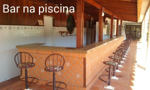 a row of bar m pizzeria with four chairs at Flat no APART-HOTEL Cavalinho Branco com PISCINA AQUECIDA 1D8 in Águas de Lindoia