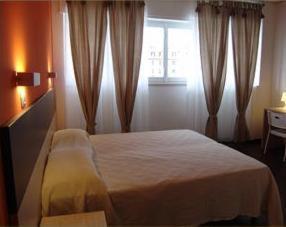 เตียงในห้องที่ Hotel Milano