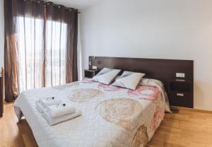 a bedroom with a large bed with a black headboard at APARTAMENTOS CASAS NOVAS in Silleda +24 photos