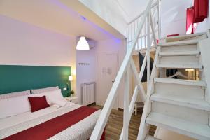 a bedroom with a white bed and a staircase at Modica Old Town Rooms in Modica