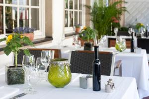 a table with a wine bottle and glasses on it at Boutique Hotel Ashley's Garden in Düsseldorf +30 photos