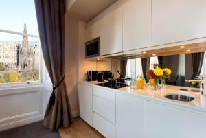 a kitchen with a counter with a sink and a window at Fraser Suites Edinburgh in Edinburgh