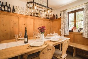 a dining room with a table with wine bottles at Gabis kleine Spezerey in Gries am Brenner