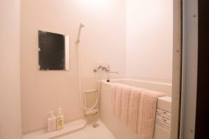 a bathroom with a bath tub and a sink at Sannand / Vacation STAY 2188 in Sapporo