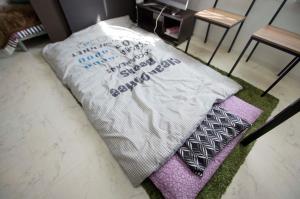 a blanket sitting on top of a rug on a floor at Sannand / Vacation STAY 2188 in Sapporo