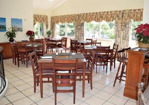 a dining room with tables and chairs and windows at Hotel Berlin in San Salvador