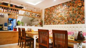 a restaurant with a table and chairs and a brick wall at Aiyaree Place Hotel SHA PLUS in Jomtien Beach