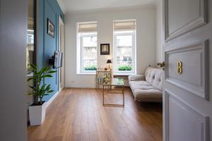 a living room with a couch and a table at Deluxe Prince Machabeli Suite in Tbilisi City